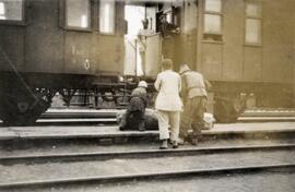 Family waiting to board a Trans-Siberian Railway rail car in northern China in 1924; written in pencil on the back: On Siberian Railway through North China 1924.