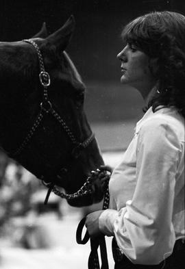 Woman holding the reins of a horse at the 1978 Little International Agricultural Exposition at South Dakota State University.