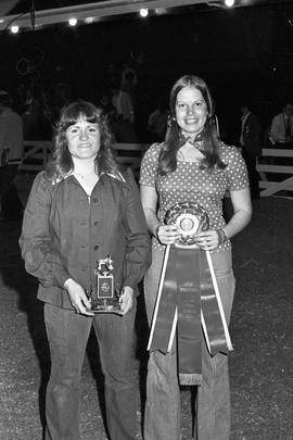 Little International Queen presenting a man with a trophy at the 1977 Little International Agricultural Exposition at South Dakota State University.