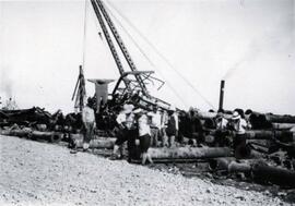 Porters lifting iron pipes at the port on Tokyo Bay at Yokohama, Japan; written in pencil on the back: Porters lifting iron pipes at Yokohama 1924.