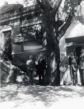 N.E. Hansen (right of tree) and his son, Carl Hansen (far right) are with three other men in Russia.