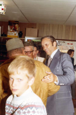 Frank Denholm greeting constituents in a café.