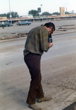 Photographer documenting the flood damage in Rapid City, South Dakota following 15 inches of rain over a small area in the Black Hills caused Rapid Creek and other waterways to overflow on June 9, 1972.
