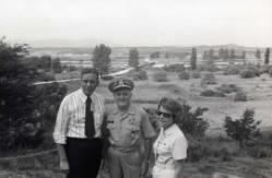 Congressman Frank Denholm and Millie Denholm with a military man during a trip to Korea