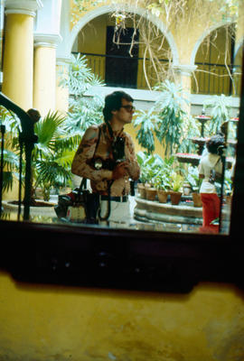 Portrait of photographer in a courtyard in Cuba