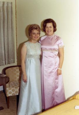 Millie Denholm (standing) and another woman dressed for the post-ceremony ball in celebration of the inauguration of South Dakota Governors Richard Kneip.