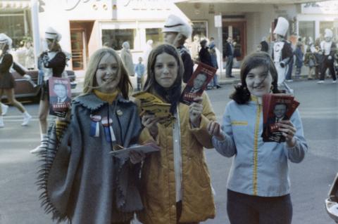 Three young volunteers handing out Denholm campaign pamphlets during a 1970 parade