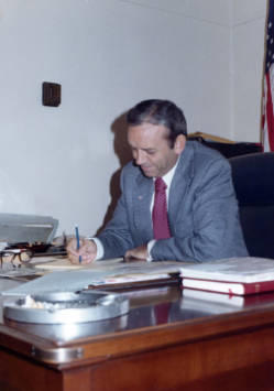 Frank Denholm working at a desk in his Washington, D.C. office.