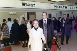 Frank and Millie Denholm walk away from the check in counter at the regional airport in Sioux Falls, South Dakota.