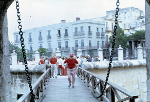 Man crossing a foot bridge at Fortaleza de San Carlos de la Caba