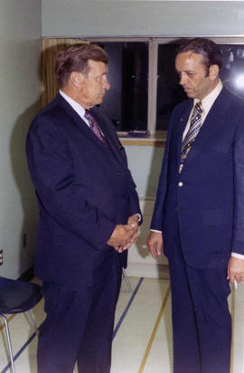Frank Denholm talking with a man at an event.
