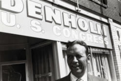 Frank Denholm standing in front of his campaign headquarters