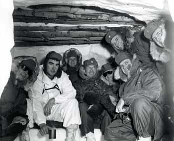 Congressman in a snow cave prepared for cold weather survival at Fort Richardson, Alaska in 1964