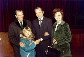 Frank Denholm is with a family at an event.