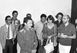 Raul Castro in military dress with press members in the background