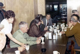 Frank Denholm having coffee with constituents in a restaurant.