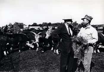 Ben Reifel talking with a farmer in a feed lot