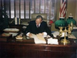 Frank Denholm working at his desk in his law office in Brookings, South Dakota