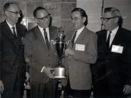 Verly Hofer, Representative Ben Reifel, Dan Van Bocbern, and Fred Coursey pose with a trophy in 1965
