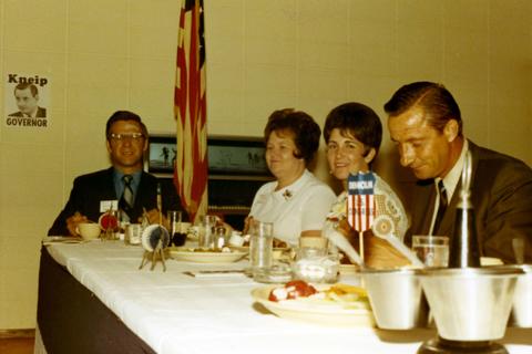 Richard and Nancy Kneip sitting at a table with other people at a luncheon during his 1970 campaign.