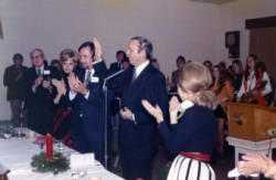 Frank Denholm speaking to a group of people at an event.