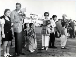 Frank Denholm and his wife Millie Denholm are being greeted by students during a trip to South Korea as part of a Congressional delegation.
