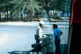 Motorcycle police officer speaking to man in Cuba