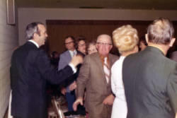 Frank Denholm greeting people at an event.