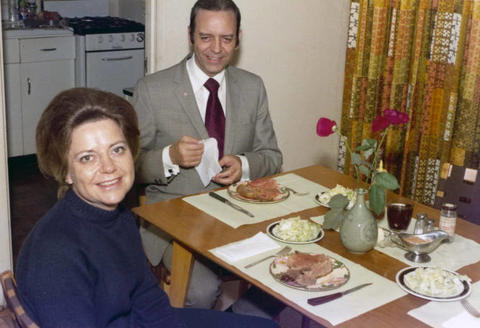 Frank and Millie Denholm seated at the dinner table in a home.