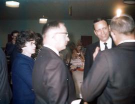 Frank Denholm talking with people at an event.