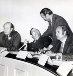 Former Assistant Secretary of Interior Ken Holum, Representative Jim Abourezk, Representative Frank Denholm (standing), and Senator George McGovern in a meeting about the Oahe Irrigation Project on the Missouri River in central South Dakota.