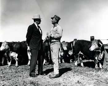 Ben Reifel talking with a farmer in a feed lot