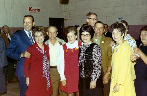 Frank and Millie Denholm with a group of people at a campaign event.