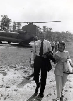 Frank and Millie Denholm walk away from a military transport helecopter on their trip to South Korea as part of a Congressional delegation.