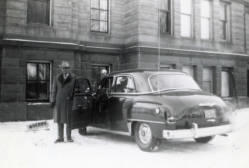 Day County, South Dakota Sheriff Frank Denholm standing by a police car