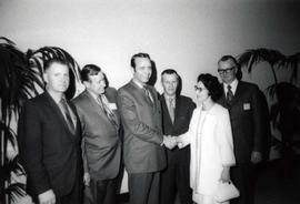 Frank Denholm with constituents at an event. Denholm is shaking hands with a woman.