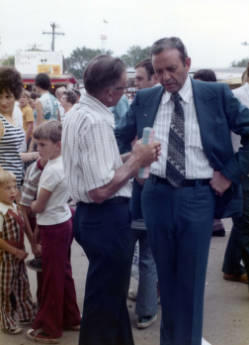Frank Denholm talking with a constituent at the South Dakota State Fair in Huron, South Dakota.