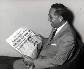 Ben Reifel reading a headline about his 1960 primary victory