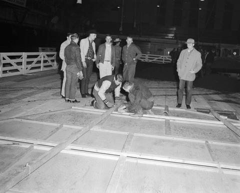 Crew constructing the arena floor in the gymnasium at South Dakota State College in preparation for the 1959 Little International Exposition.