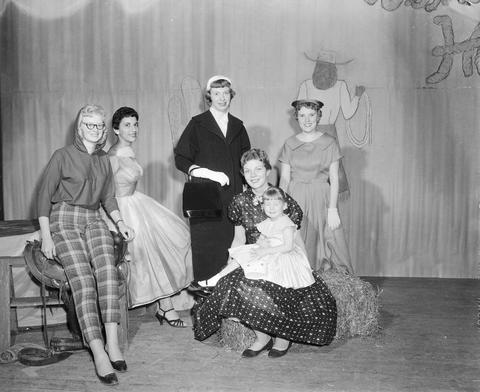 Five women and a little girls model clothing during a fashion show at the 1958 Little International Exposition at South Dakota State College.