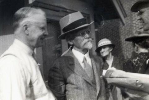 N.E. Hansen (wearing hat) is with friends in Brookings, South Dakota; writing on the back: S.D. plant wizard and friends Brookings 5-19-39 compliments York Sampson.