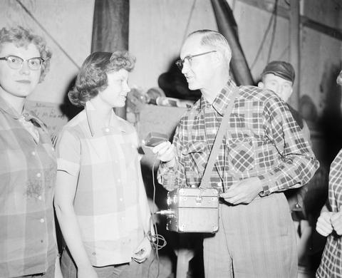 George B. German, WNAX radio, conducting an interview at the 1953 Little International Exposition at South Dakota State College.