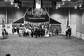 Large group of people pose for a photo in front of the stage at the 1986 Little International Agricultural Exposition at South Dakota State Universit