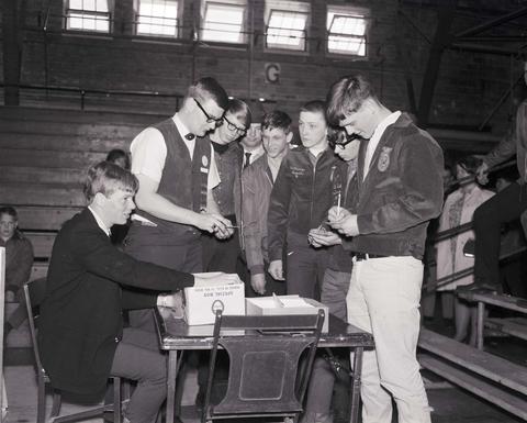 Future Farmers of America students signing up for a raffle at the 1968 Little International Exposition at South Dakota State University.