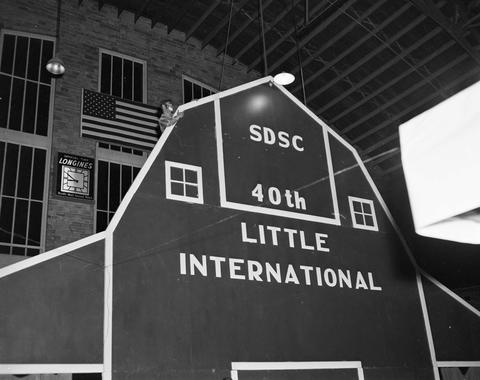 False barn wall with SDSC 40th Little International in the gymnasium for the 1963 Little International Exposition at South Dakota State College.