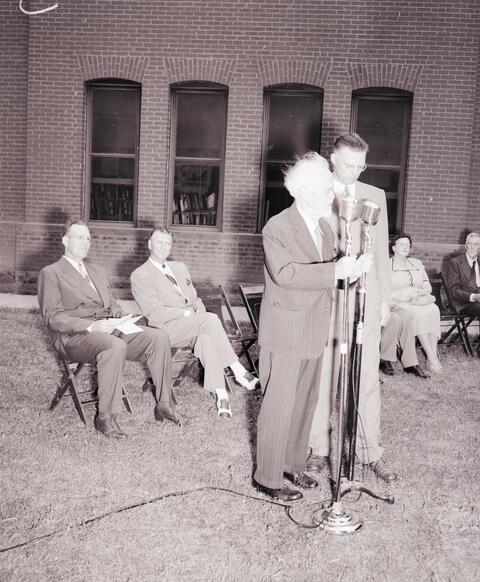 N.E. Hansen responds when the monument erected in his honor was unveiled at South Dakota State College; left to right: State College President Leinbach, Governor Mickelson, Dr. Hansen, Carl Hansen, Lucille Dory.