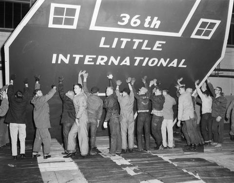 Crew erecting the false barn wall in the gymnasium at South Dakota State College in preparation for the 1959 Little International Exposition