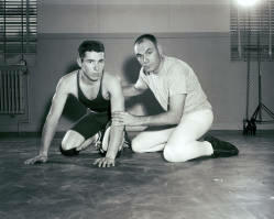 SDSU coach Warren Williamson with Jim Perkins posed mid training. Perkins was a senior ag major from Worthington, Minnesota.