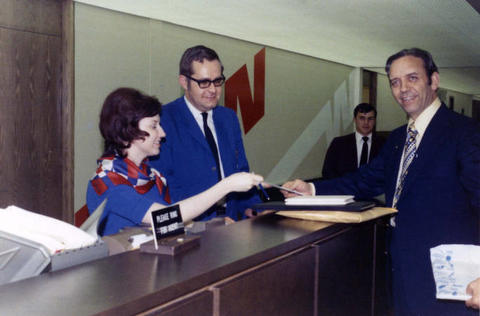 Frank Denholm standing at the Northwest ticket counter at the Sioux Falls Regional Airport.