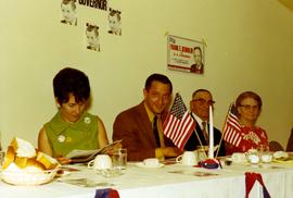 Richard and Nancy Kneip sitting at a table with other people at a luncheon during his 1970 campaign.